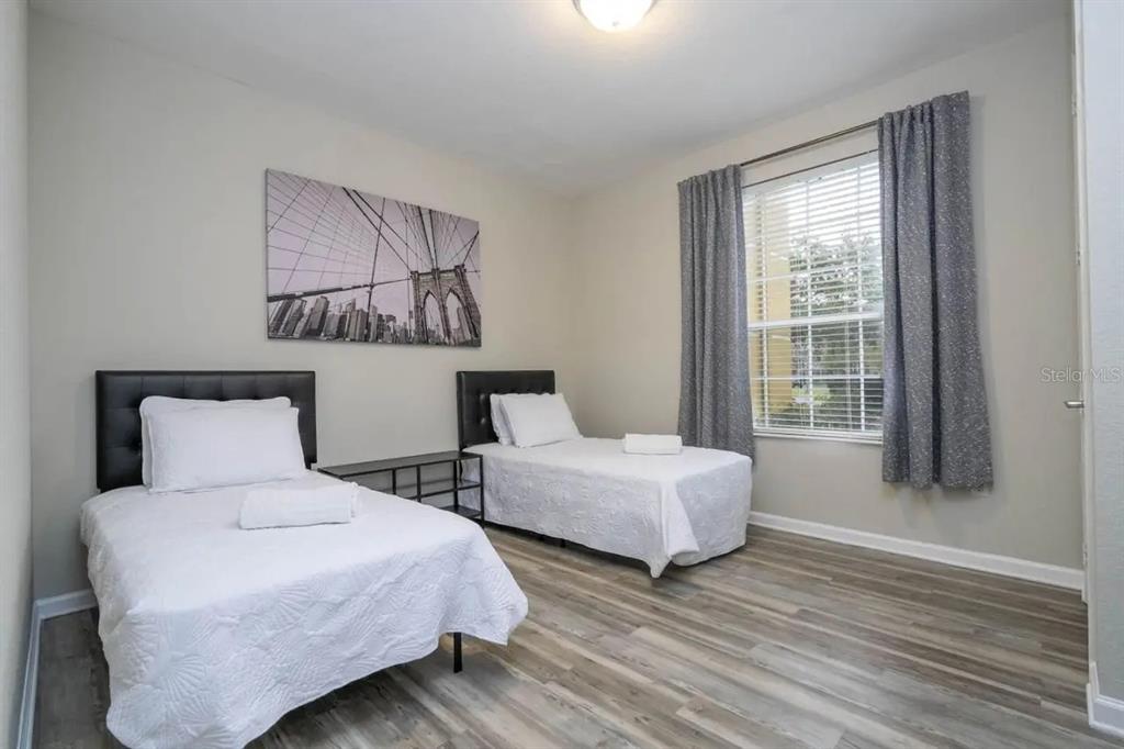 5025 Shoreway Loop, Unit 10703 Orlando, FL 32819 - Photo 22 of 53 a bedroom with two beds and a large window