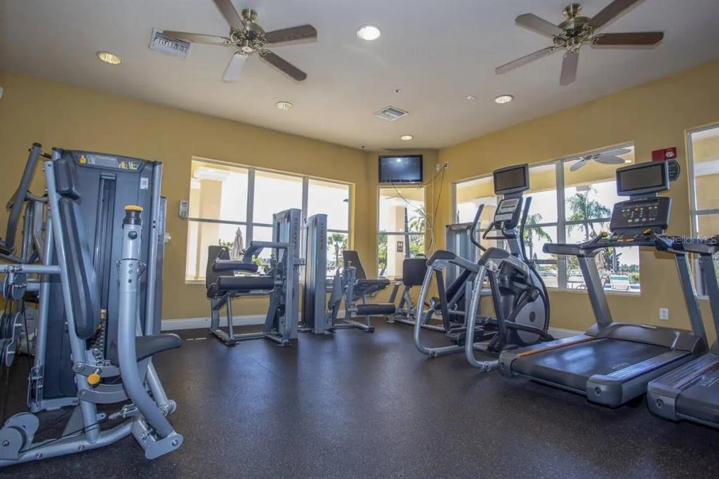 5025 Shoreway Loop, Unit 10703 Orlando, FL 32819 - Photo 32 of 53 a view of a room with gym equipment