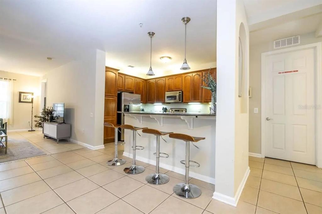 5025 Shoreway Loop, Unit 10703 Orlando, FL 32819 - Photo 5 of 53 a open kitchen with cabinets and stainless steel appliances