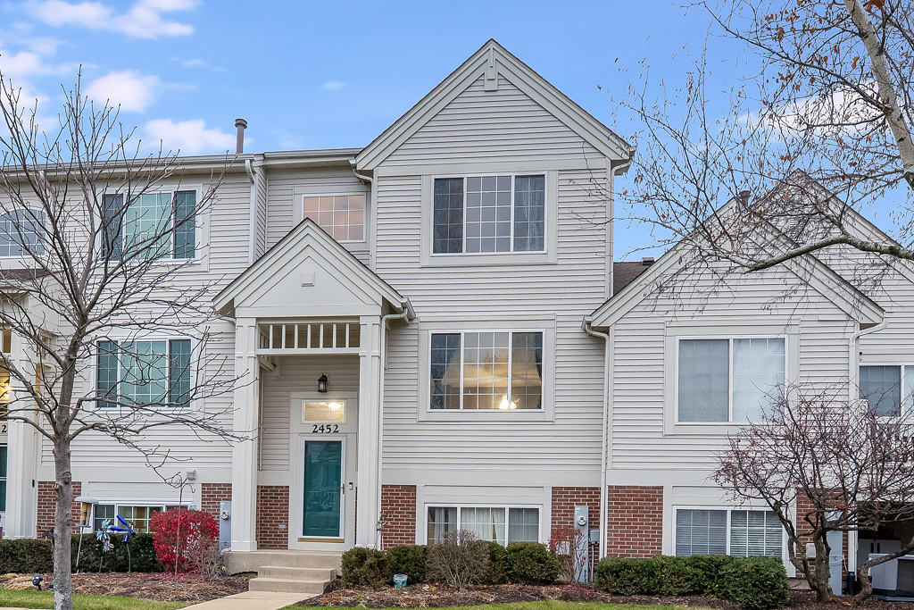 2452 Daybreak Court, Unit 2452 Elgin, IL 60123 - Photo 1 of 22 a front view of a house with a yard