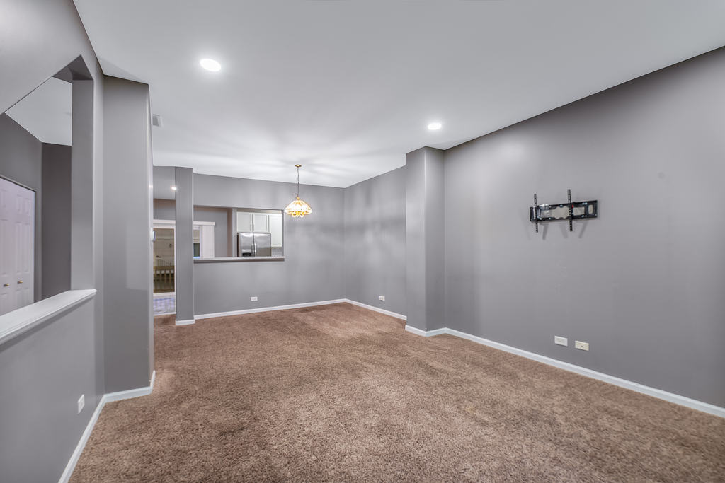 2452 Daybreak Court, Unit 2452 Elgin, IL 60123 - Photo 11 of 22 a view of a big room with wooden cabinet and windows