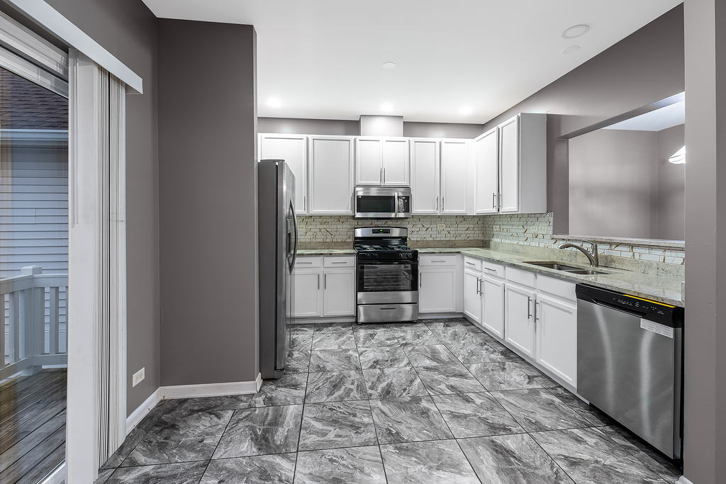 2452 Daybreak Court, Unit 2452 Elgin, IL 60123 - Photo 4 of 22 a kitchen with stainless steel appliances granite countertop a refrigerator and a sink