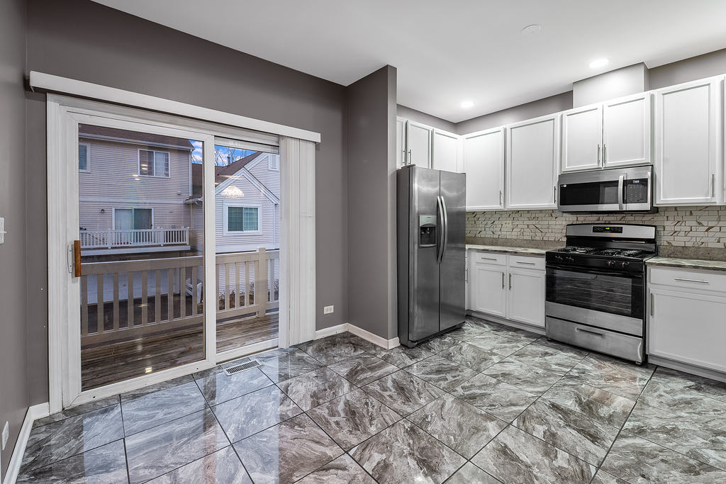2452 Daybreak Court, Unit 2452 Elgin, IL 60123 - Photo 6 of 22 a kitchen with stainless steel appliances a refrigerator and a stove top oven