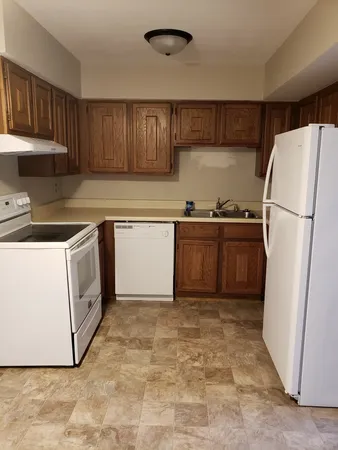 a kitchen with a cabinets a sink and a stove