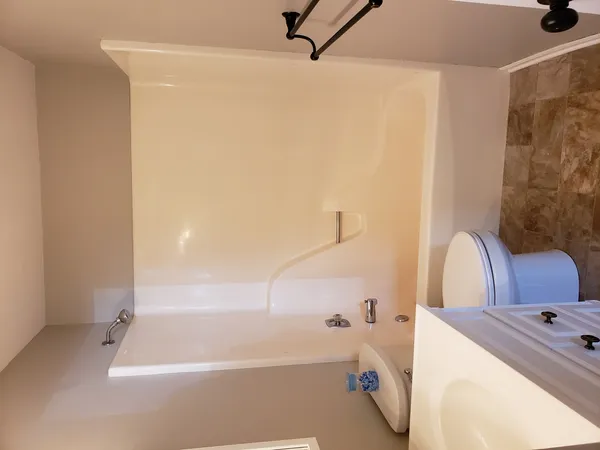 a bathroom with a tub sink and a shower