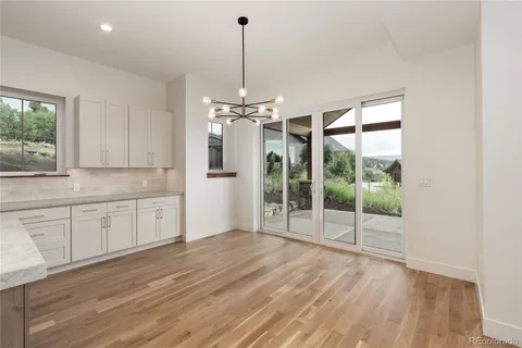 a view of a kitchen with wooden floor and a sink