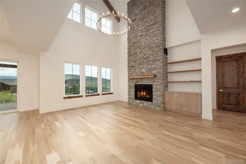 a view of an empty room with a fireplace and a window