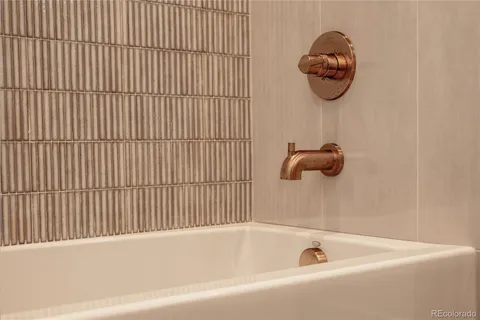 a bathroom with a tub and a shower