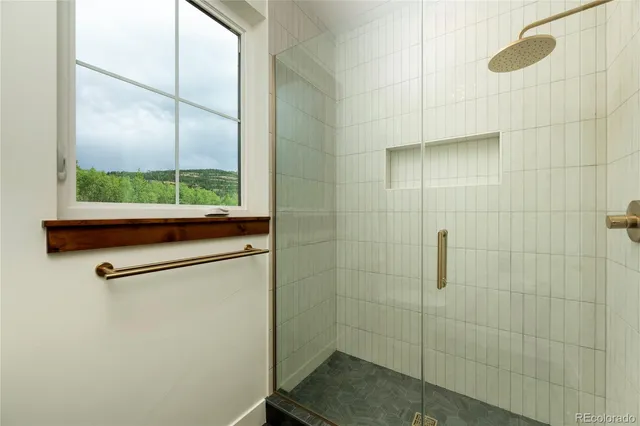 a bathroom with a shower and a window