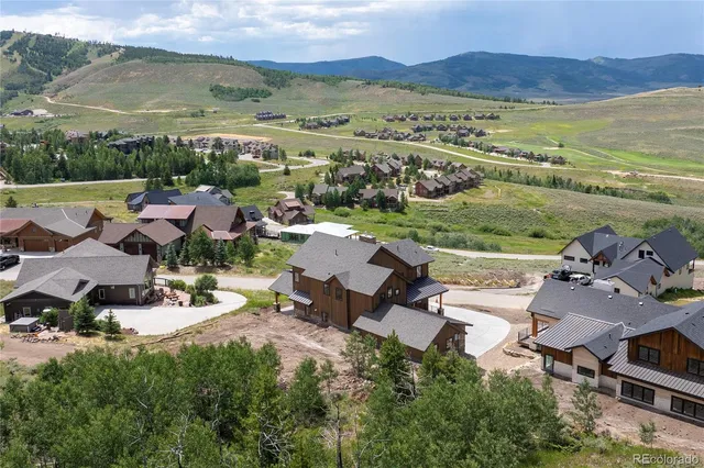 an aerial view of a houses with a lake view and mountain view