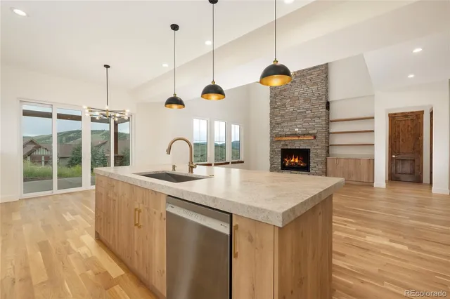 a view of a kitchen with a sink and a wooden floor
