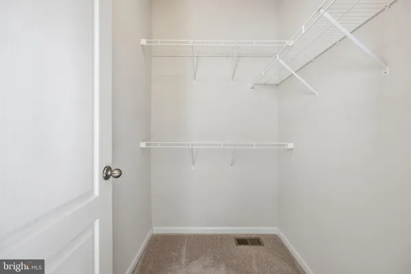a view of storage and utility room with racks on the wall