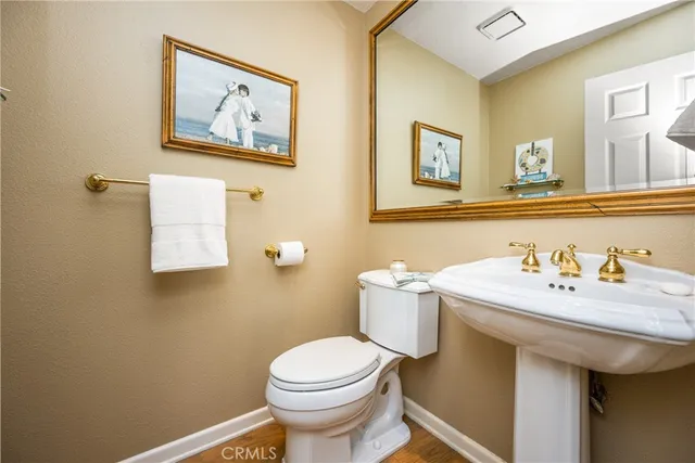a bathroom with a sink mirror and toilet
