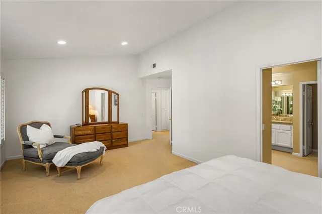 a bedroom with furniture and a window