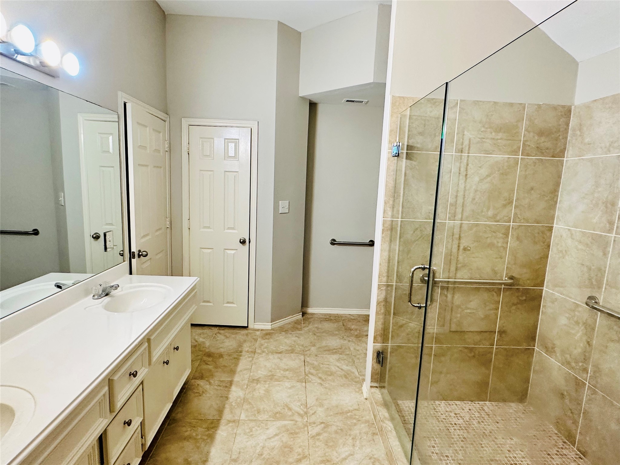 5643 Walnut Glen Lane Rosenberg, TX 77471 - Photo 19 of 35 a spacious bathroom with a shower sink and mirror