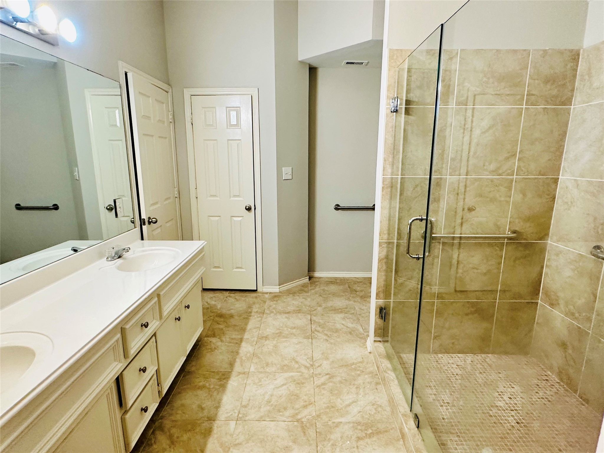 5643 Walnut Glen Lane Rosenberg, TX 77471 - Photo 23 of 35 a bathroom with a double vanity sink and mirror