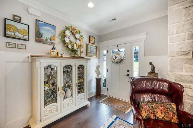 a view of an entryway with wooden floor and furniture