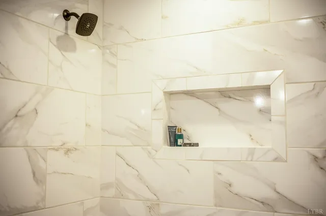 a front view of a house with a garden and lake view