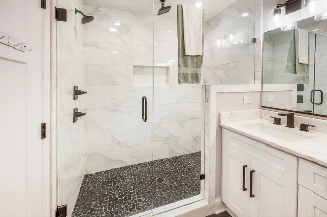 a living room with furniture and a dining table with kitchen view
