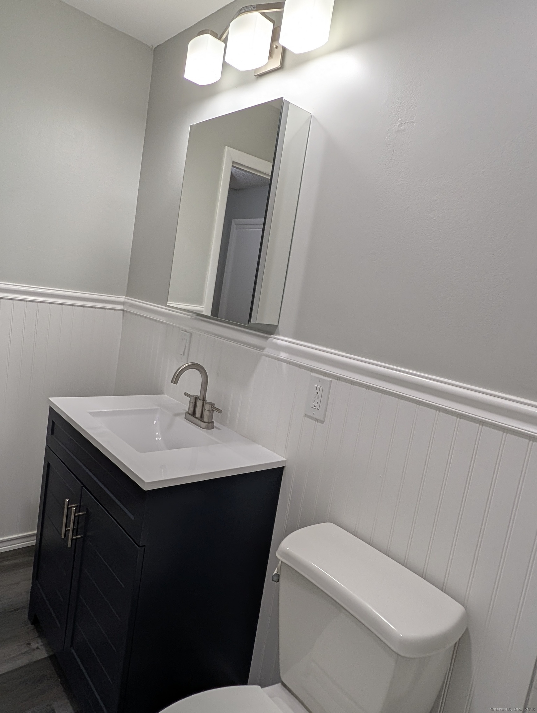 161 West Spring Street, Unit B2 West Haven, CT 06516 - Photo 7 of 17 a bathroom with a toilet sink and mirror