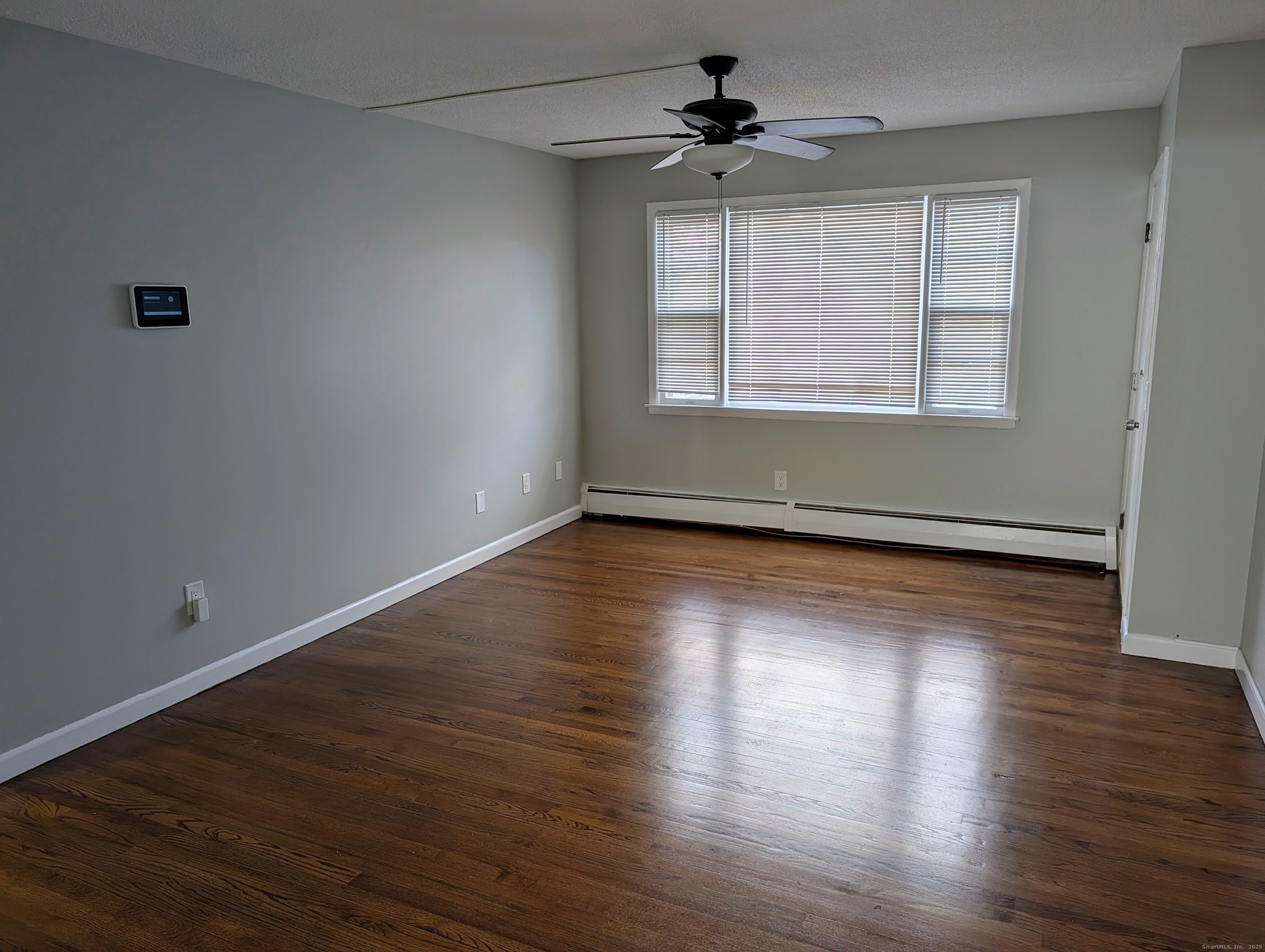 161 West Spring Street, Unit B2 West Haven, CT 06516 - Photo 8 of 17 a view of an empty room with wooden floor and a window