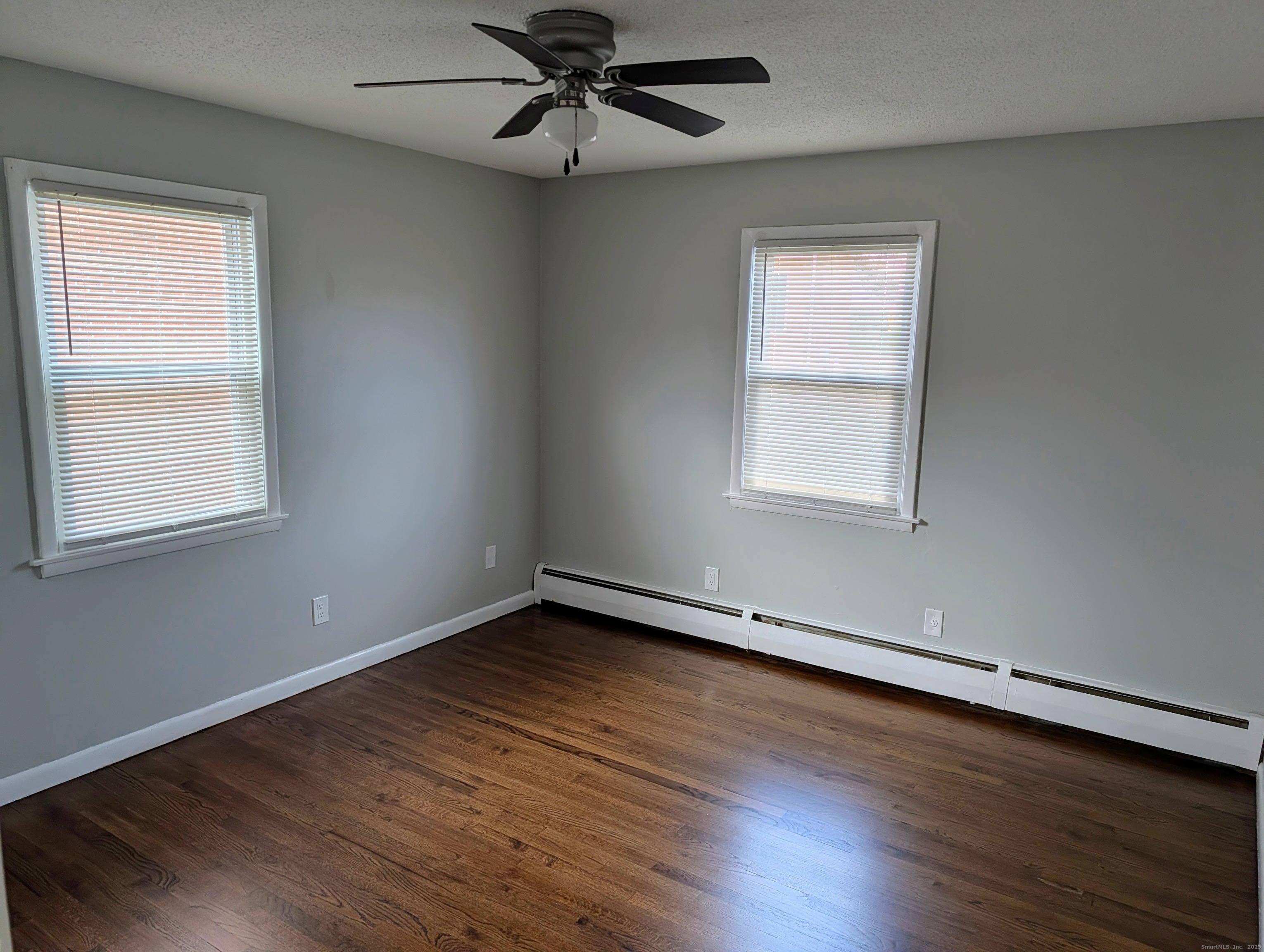 161 West Spring Street, Unit B2 West Haven, CT 06516 - Photo 9 of 17 a view of an empty room with wooden floor and a window