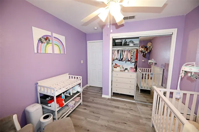 a bedroom with furniture and a baby crib
