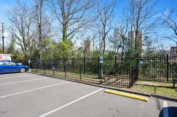a view of a tennis court with large trees