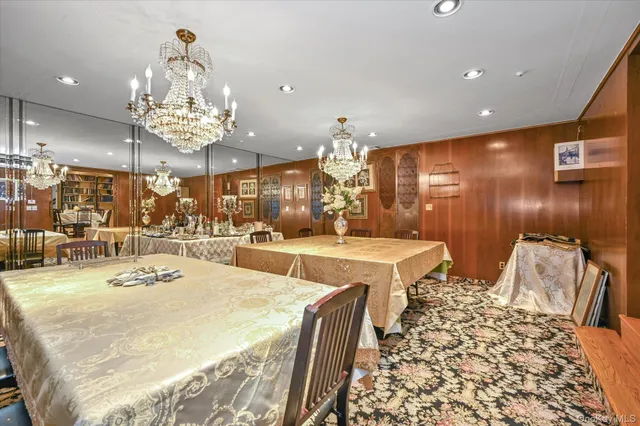 a large bathroom with a sink a large mirror and a chandelier