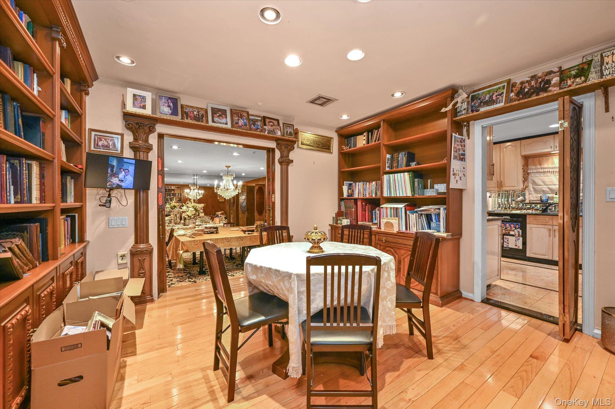 147-01 70th Avenue Queens, NY 11367 - Photo 12 of 21 a view of a dining room with furniture and a book shelf