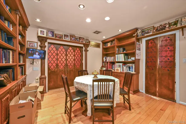 a dining room with furniture and a book shelf