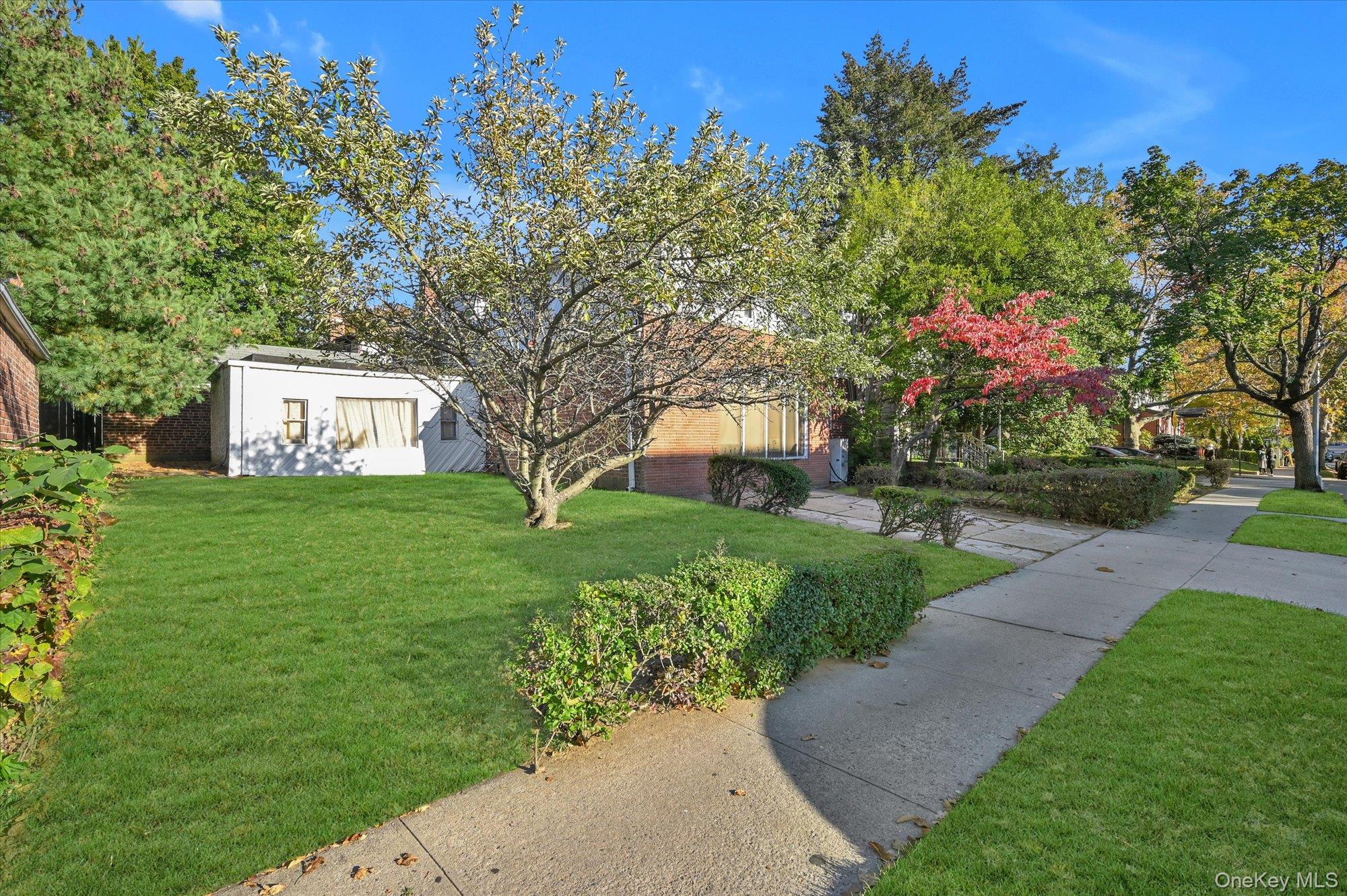 147-01 70th Avenue Queens, NY 11367 - Photo 14 of 21 a front view of a house with garden