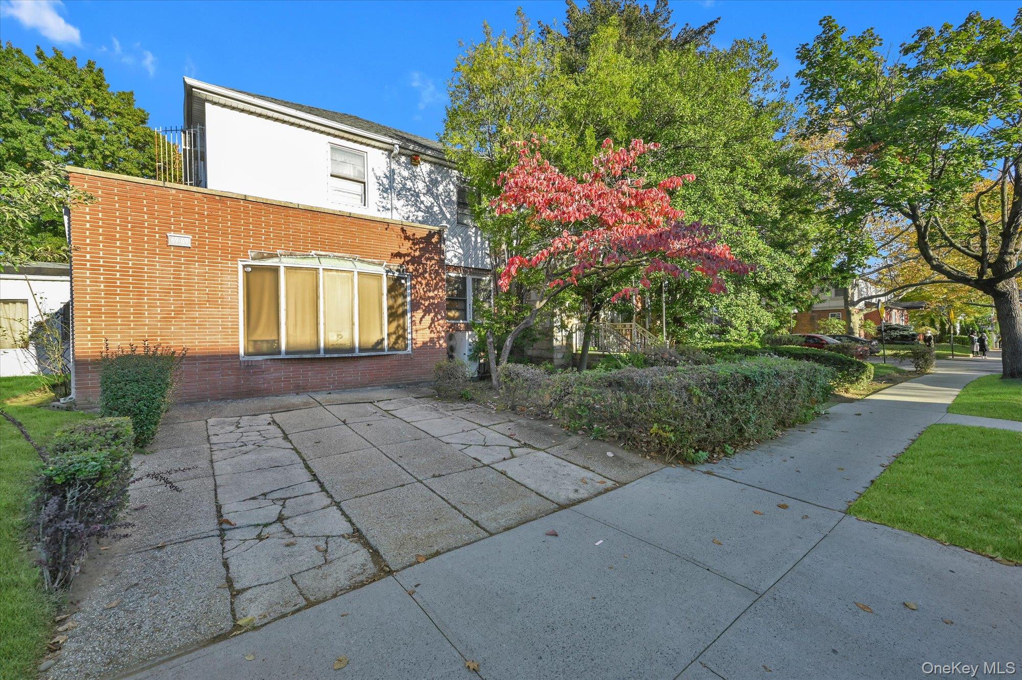 147-01 70th Avenue Queens, NY 11367 - Photo 16 of 21 a front view of a house with a yard and potted plants