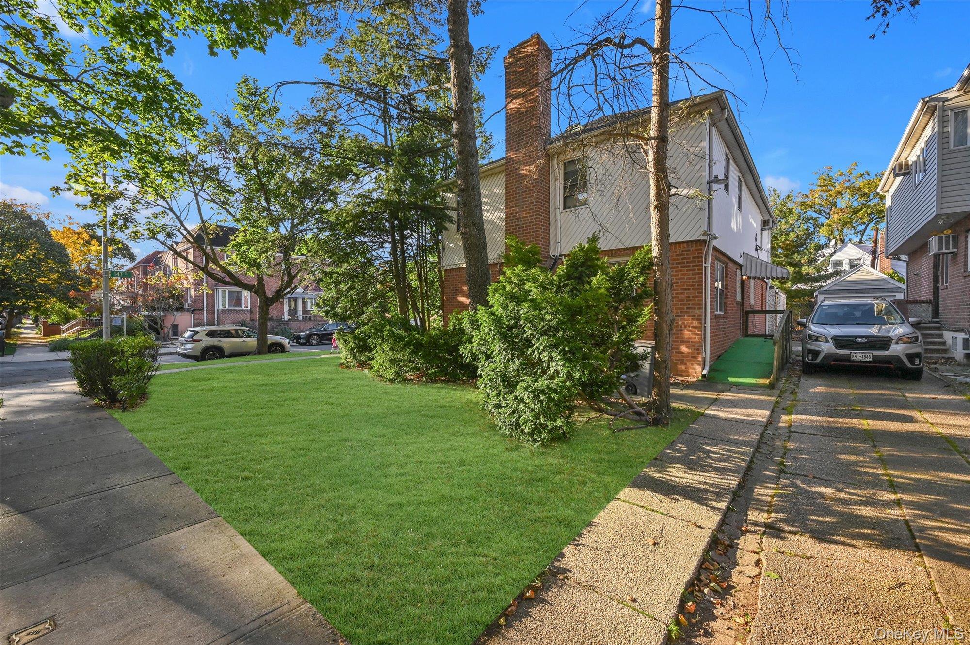 147-01 70th Avenue Queens, NY 11367 - Photo 17 of 21 a front view of a house with a yard