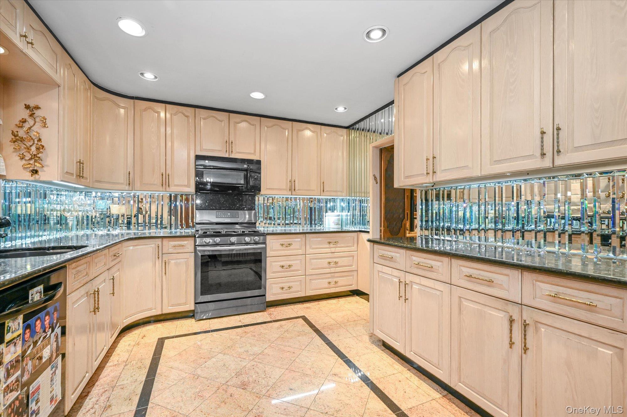 147-01 70th Avenue Queens, NY 11367 - Photo 6 of 21 a kitchen with stainless steel appliances granite countertop a stove a sink and a microwave