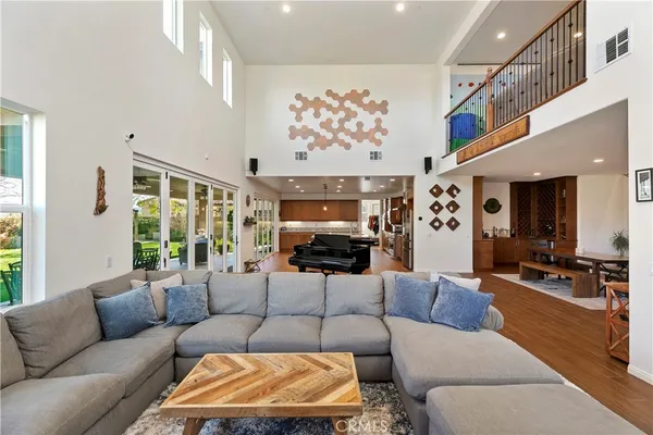 a kitchen with kitchen island granite countertop a table chairs sink and wooden floor