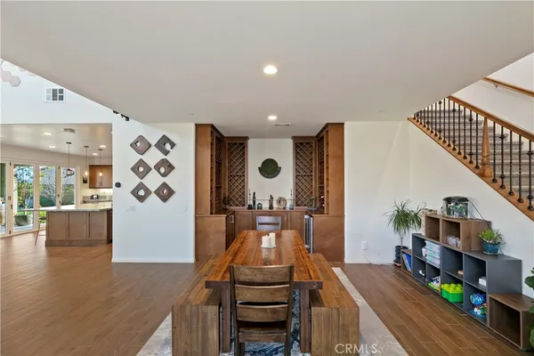 a kitchen with stainless steel appliances granite countertop a sink a stove and a wooden floors