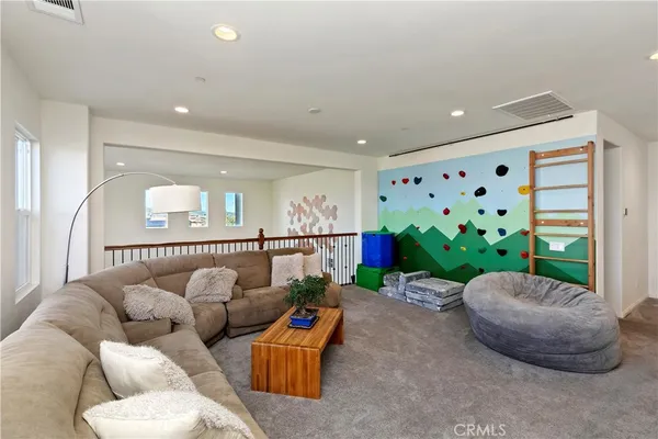 a living room with granite countertop furniture and a open kitchen view