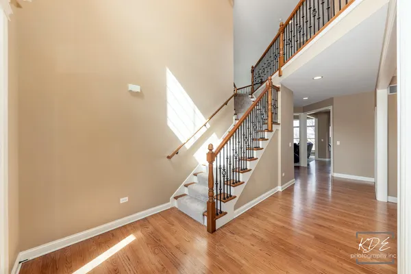 a view of entryway and hall with wooden floor