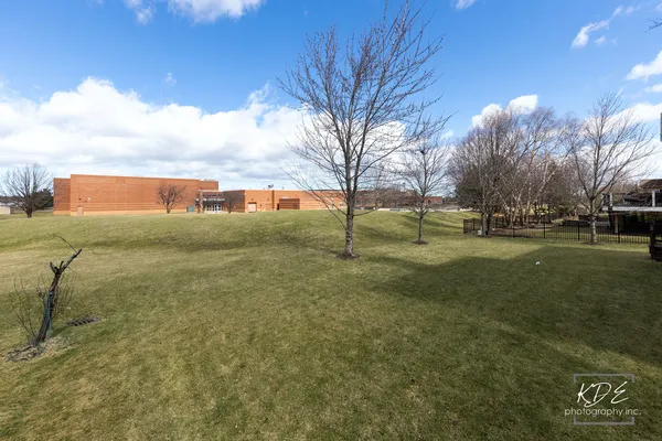 an aerial view of a house with outdoor space and lake view in back