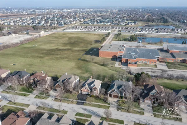 an aerial view of a house with a yard basket ball court and outdoor seating