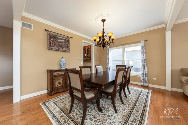 a dining room with furniture and wooden floor