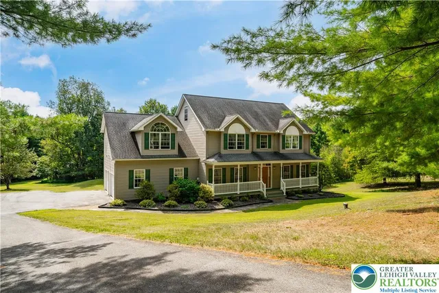 a view of a white house with a swimming pool