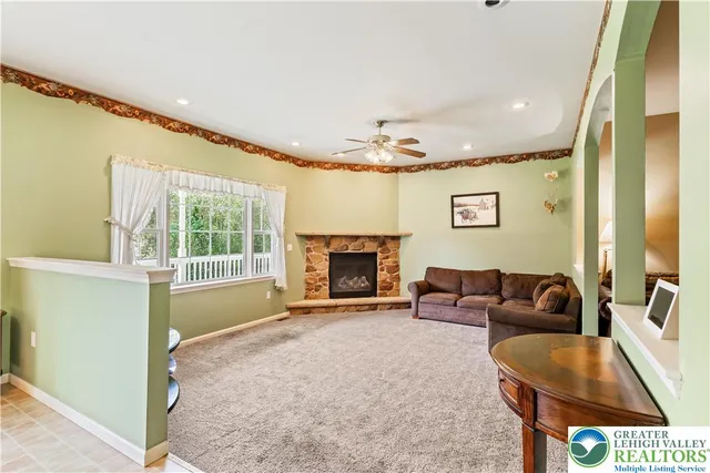 a living room with furniture and a fireplace