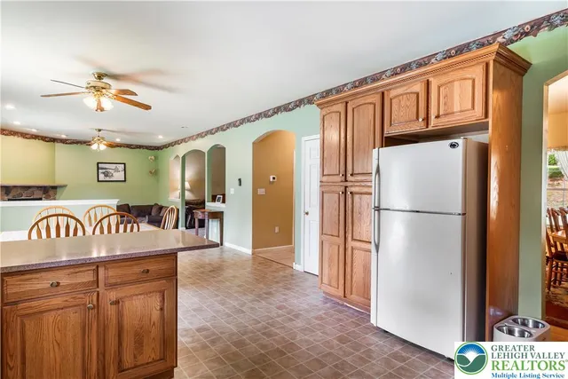 a kitchen with stainless steel appliances granite countertop a refrigerator a oven a sink and dishwasher