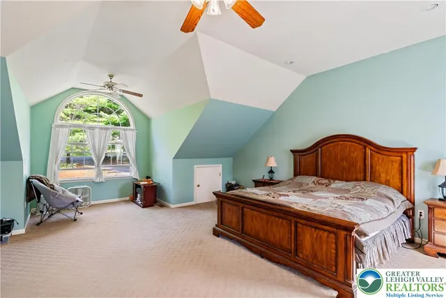 a bedroom with a bed and a table chair