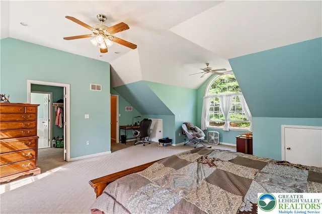 a bed room with a bed a window and a chandelier