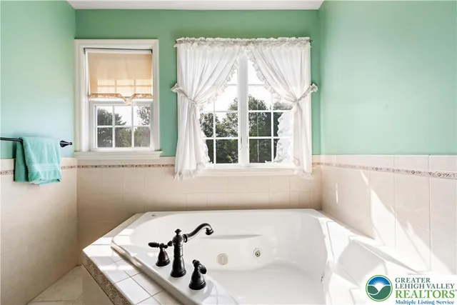 a bath tub sitting in a bathroom next to a window