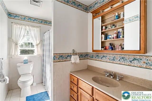 a bathroom with a sink a toilet and shower curtain