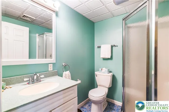 a bathroom with a sink vanity mirror and toilet